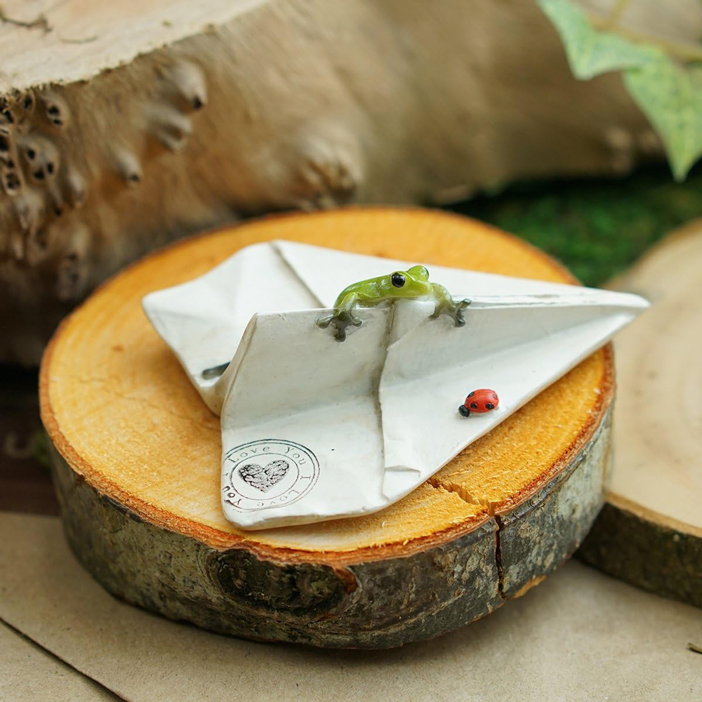 curious frog and ladybug on a paper airplane5