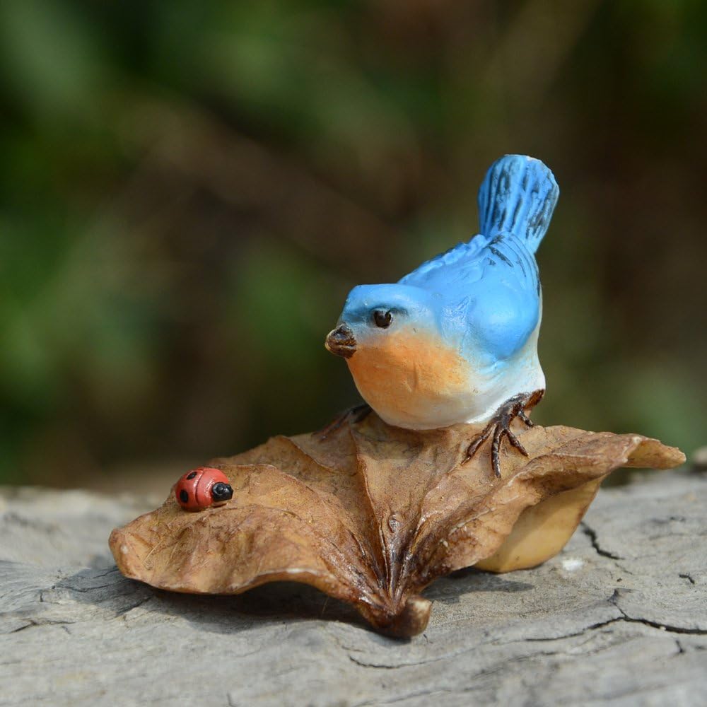 bluebird on leaf with ladybug